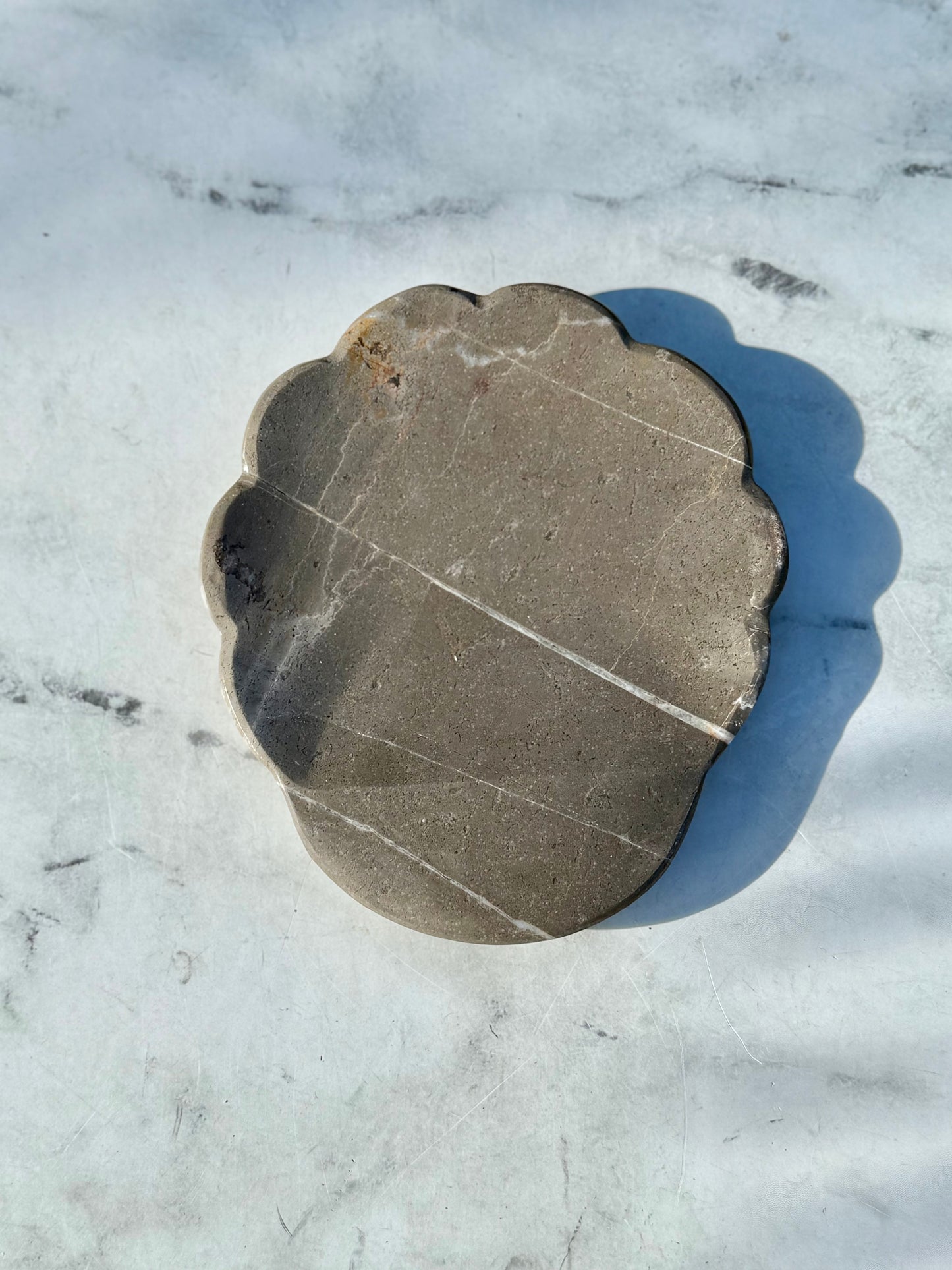 Artisan-crafted gray marble spoon rest handmade in Mexico, showcasing unique natural stone variations
