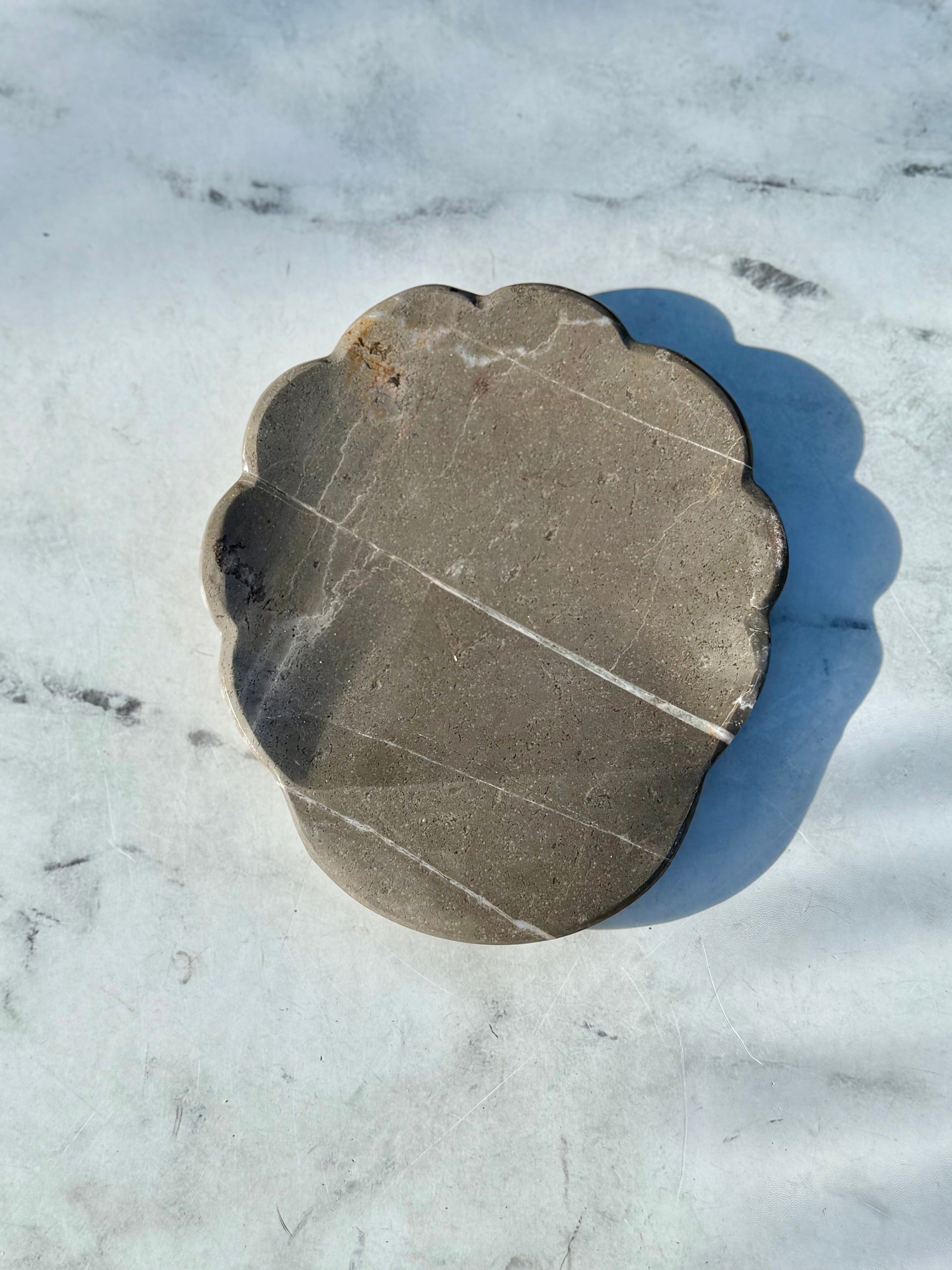Artisan-crafted gray marble spoon rest handmade in Mexico, showcasing unique natural stone variations
