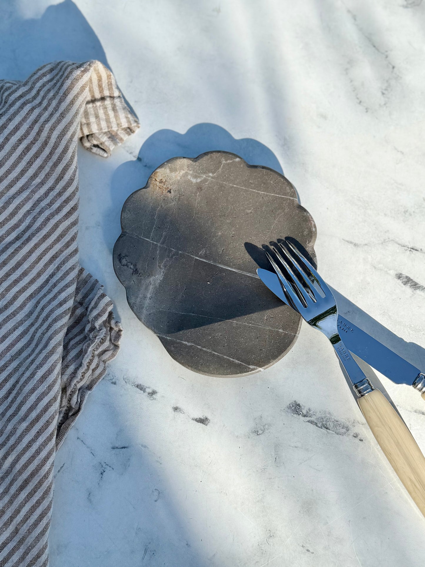 Close-up of natural veining and color variation in handcrafted gray marble spoon rest