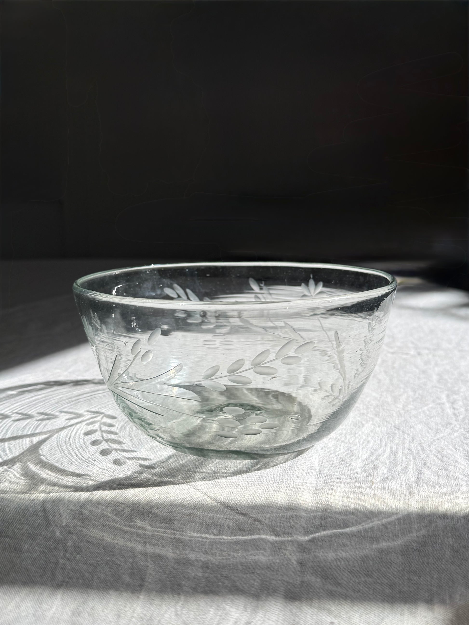 Handblown recycled glass serving bowl featuring hand-etched floral detailing and organic form