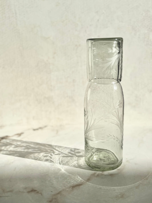 Etched tall carafe and glass set handcrafted from recycled glass with artisanal variations