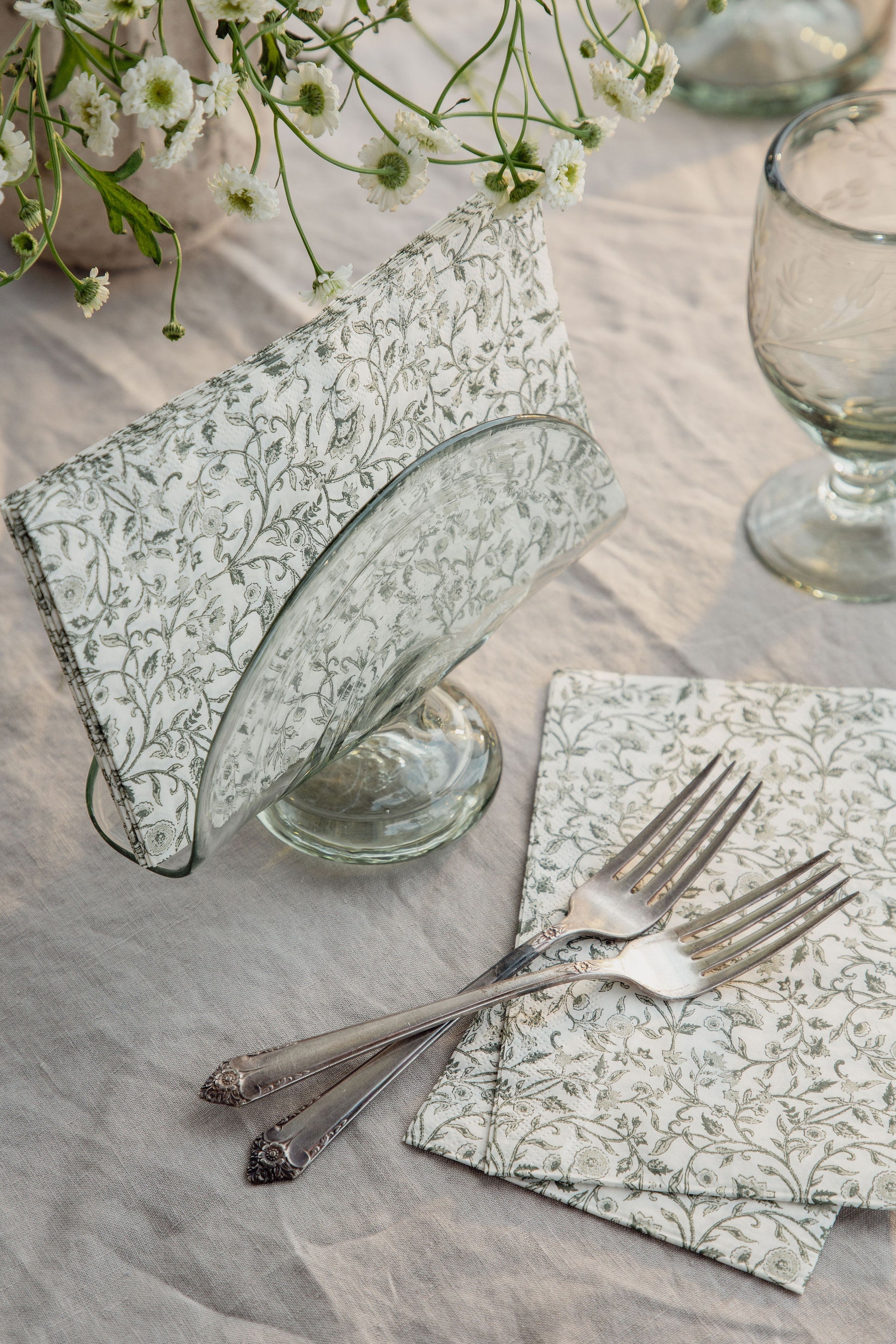 Close-up of handblown recycled glass napkin holder showing texture, air bubbles, and artisan character