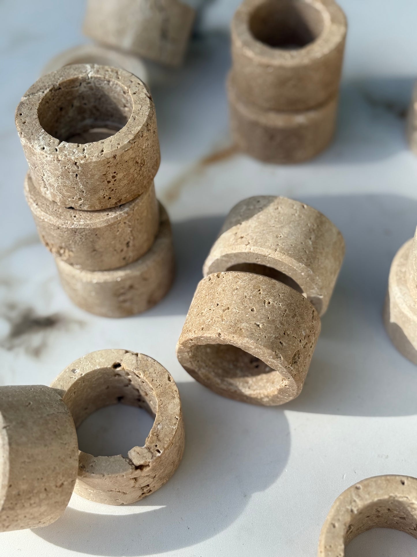 Close-up of natural travertine texture on handcrafted stone napkin ring