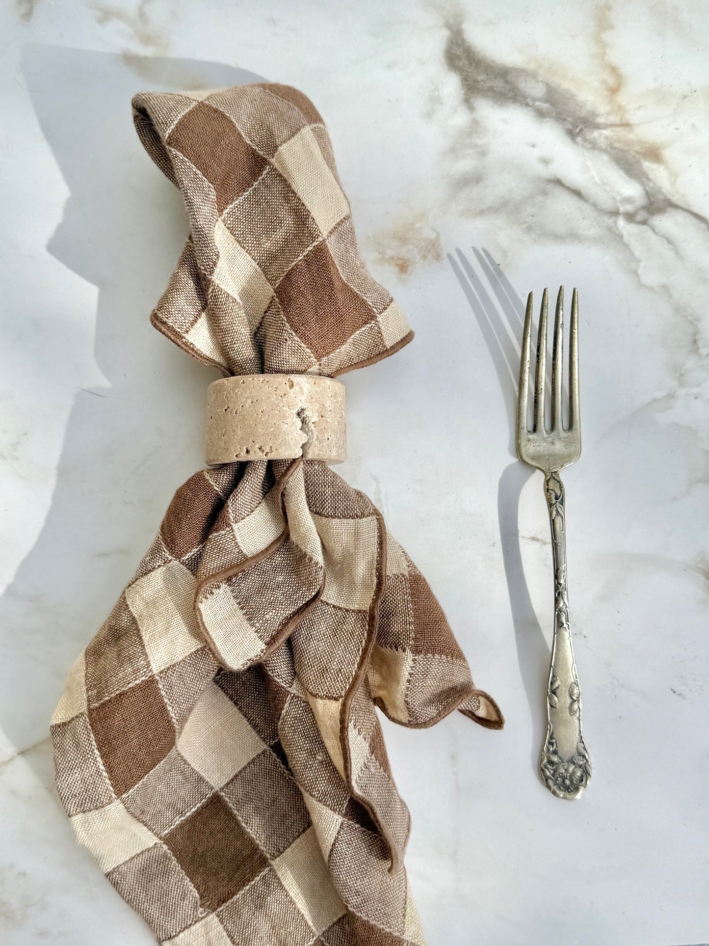Travertine napkin ring styled on a table setting with rustic, elegant appeal
